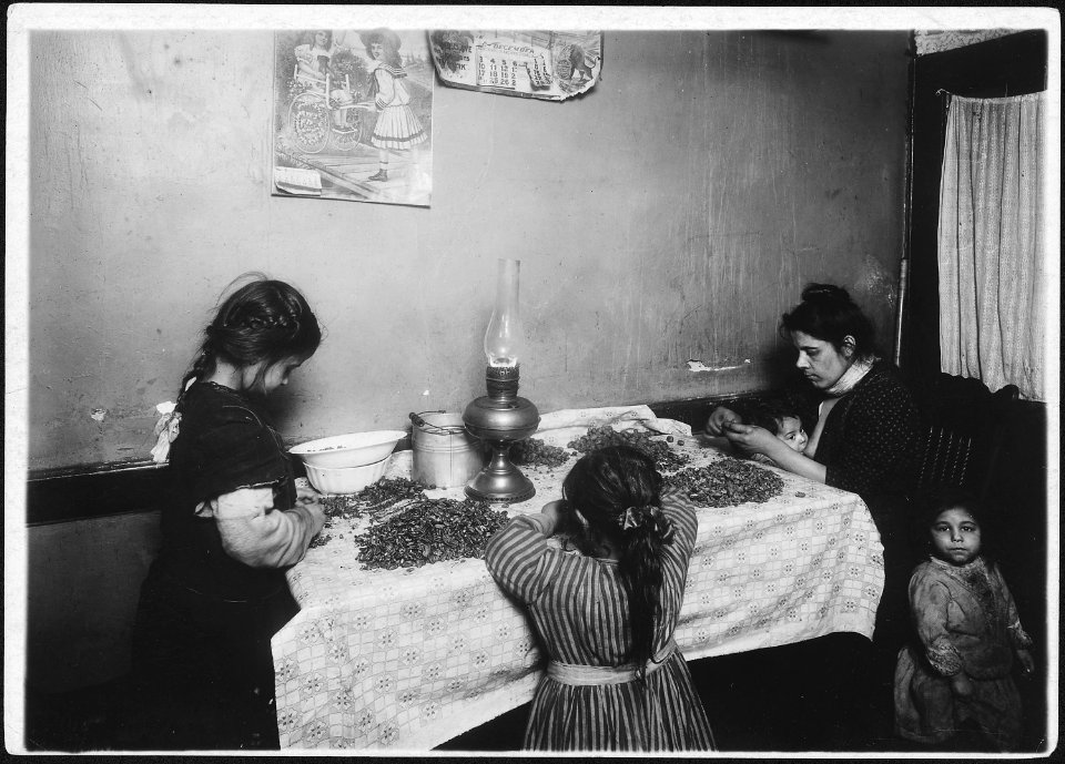 A family picking nuts. Mother nursing baby while picking nuts. Was suffering with a sore throat. Rosie, 3, hanging... - NARA - 523498