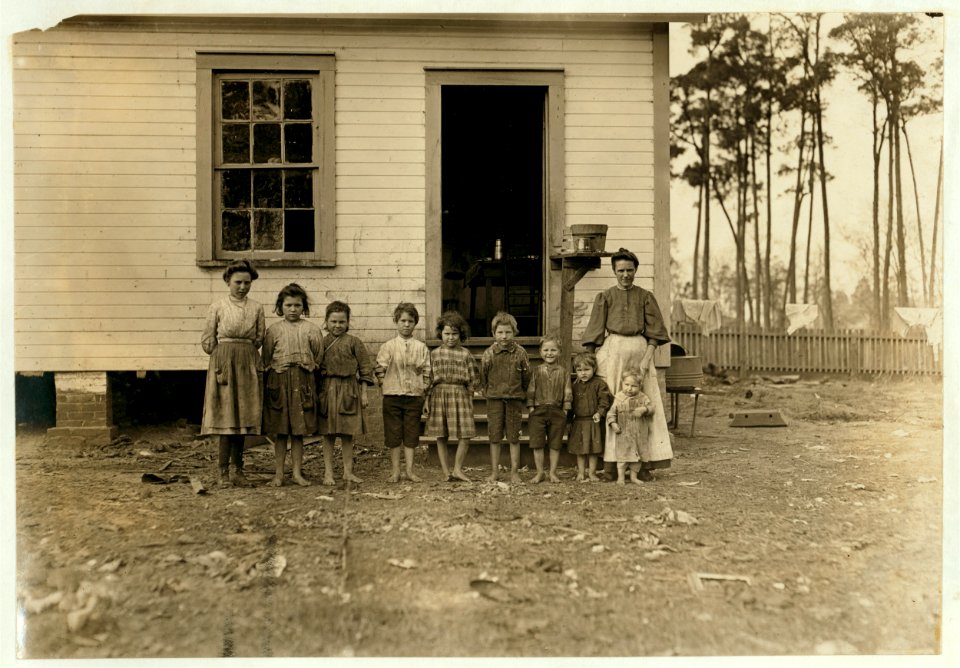 A family working in the Tifton (Ga.) Cotton Mill. Mrs. A.J. young works in mill and at home. Nell (oldest girl) alternates in mill with mother. Mammy (next girl) runs 2 sides. Mary (next) LOC cph.3a29768