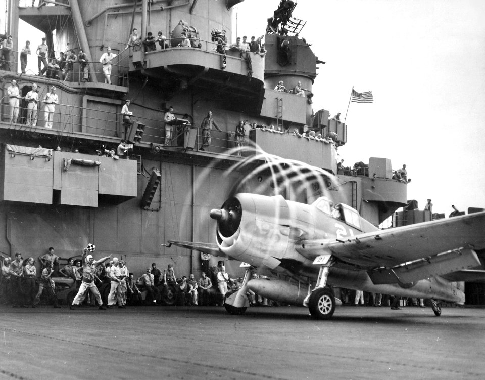 A F6F-3 Hellcat from VF-5 makes condensation rings aboard USS Yorktown (CV-10), 20 November 1943 (520641)