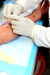 A female Afghan student administers an IV (4509653817)