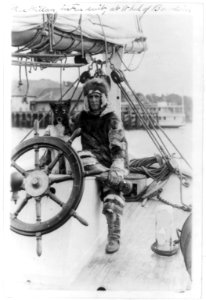 Arctic explorer Donald MacMillan in fur suit at wheel of ship Bowdoin LCCN2003653744