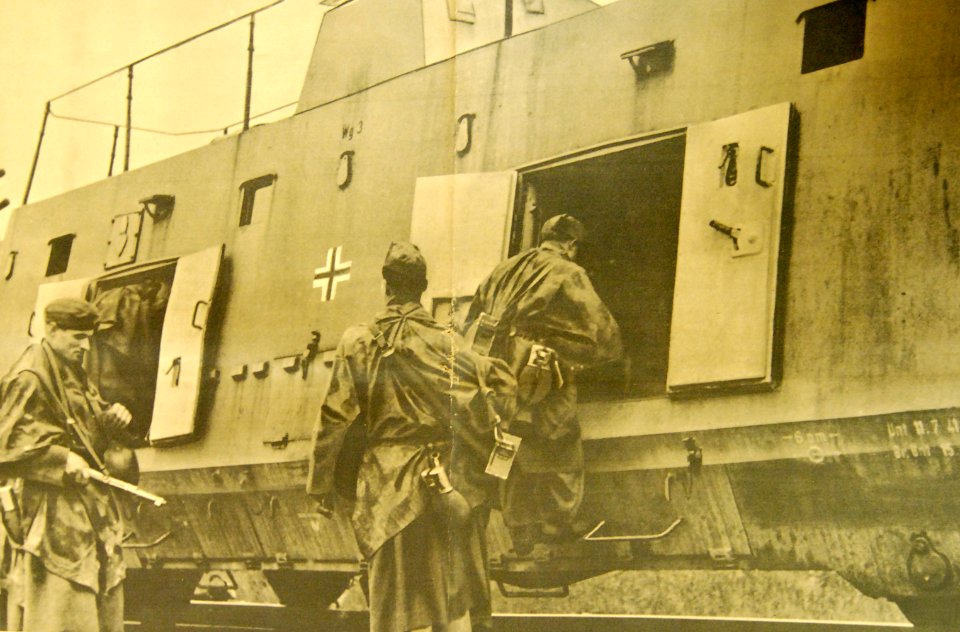 Armed hunters in Croatia entering railcar on tracks recently repaired (33339712914)