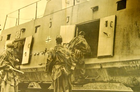 Armed hunters in Croatia entering railcar on tracks recently repaired (33339712914)