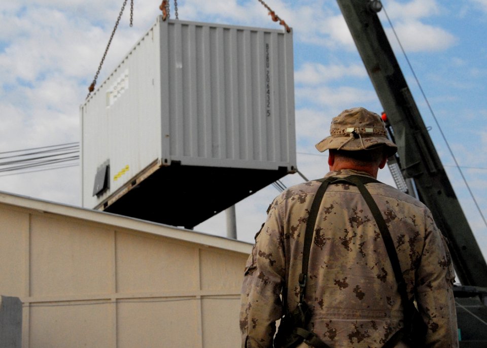 Armored crane moves shipping containers while expanding the ROLE 3 Hospital on Kandahar Airport -d