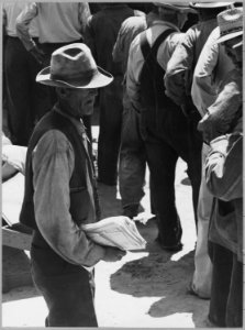 Arvin, Kern County, California. ... Close-up of relief queue on S.R.A. pay day. Man in foreground is . . . - NARA - 521652 photo