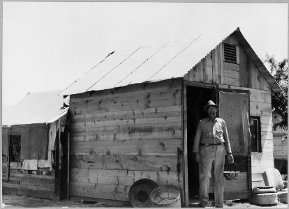 Arvin, Kern County, California. Man in doorway, I'm paying $7 a month for this rig right here and w . . . - NARA - 521658
