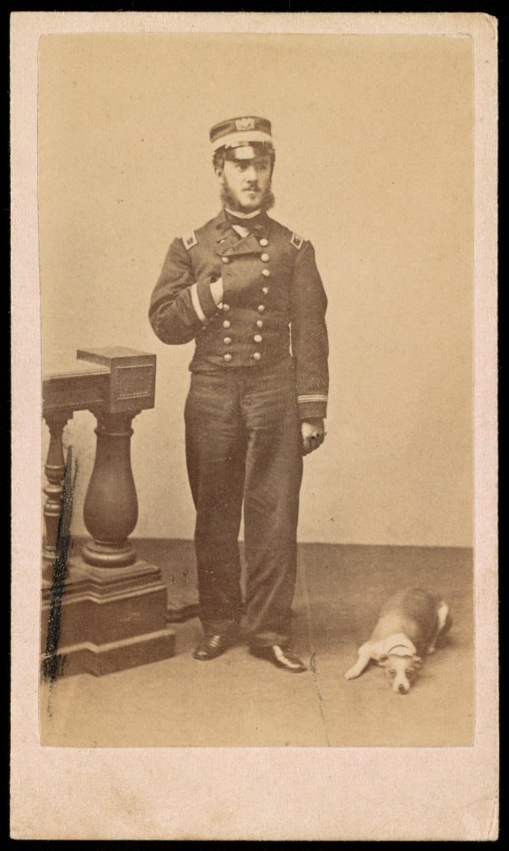 Assistant Paymaster J.D. Husbands, Jr., of U.S. Navy in uniform with dog) - J.W. Black, 173 Washington St., Boston LCCN2016647922