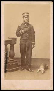 Assistant Paymaster J.D. Husbands, Jr., of U.S. Navy in uniform with dog) - J.W. Black, 173 Washington St., Boston LCCN2016647922