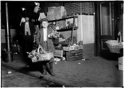 At center market. 11 year old celery vender. He sold until 11 P.M. and was out again Sunday morning selling papers... - NARA - 523535 photo