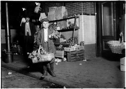 At center market. 11 year old celery vender. He sold until 11 P.M. and was out again Sunday morning selling papers... - NARA - 523535 photo
