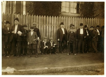 At side of mill gate (western gate beside office) Manuel Andrew, 14 Windsor St. Smallest in the picture; apparently under 14. See -2290. Manuel Jason, 58 First St. Thinnest in the picture; LOC nclc.02212