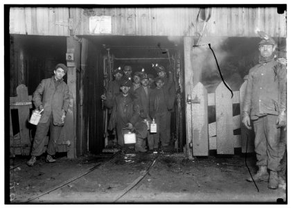 At the close of the day. Waiting for the cage to go up. The cage is entirely open on two sides and not very well protected on other two, and is usually crowded like this. Small boy in front LOC cph.3b06961