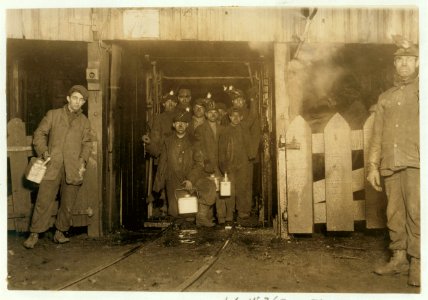 At the close of the day. Waiting for the cage to go up. The cage is entirely open on two sides and not very well protected on other two, and is usually crowded like this. Small boy in front LOC cph.3b06961 photo