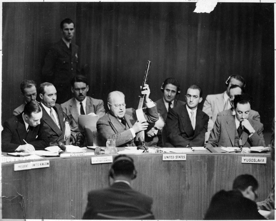 At United Nations Security Council, Warren Austin, U.S. delegate, holds Russian-made sub-machine gun dated 1950... - NARA - 541962