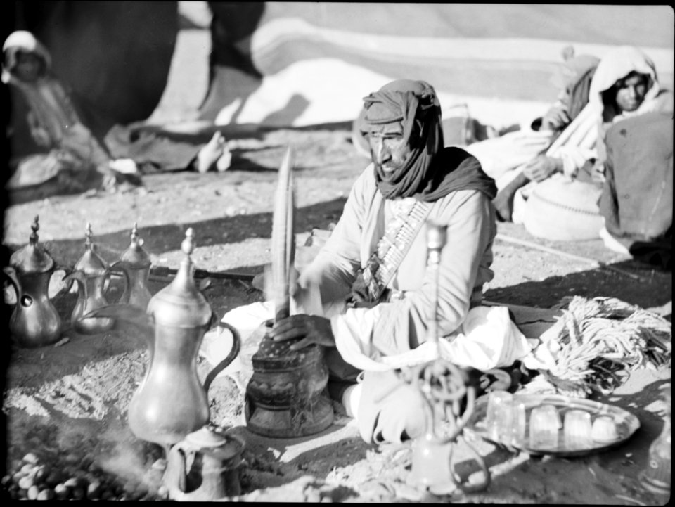 Bedouin life in Trans-Jordan. Pounding coffee to a rhythmic tune LOC matpc.15661
