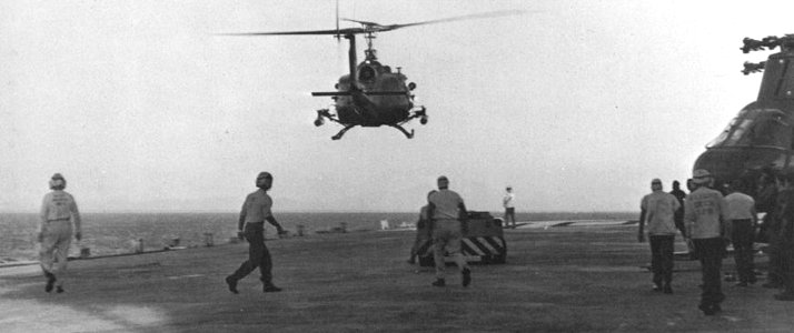 Bell UH-1E in flight over USS Tripoli (LPH-10) off Vietnam, in 1967