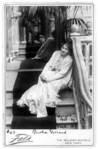 Bertha Galland, full length, seated on staircase, facing left LCCN2005683736