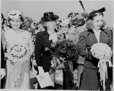 Bess Truman, Margaret Truman and another woman, standing with bouquets during the christening ceremony for two... - NARA - 199104