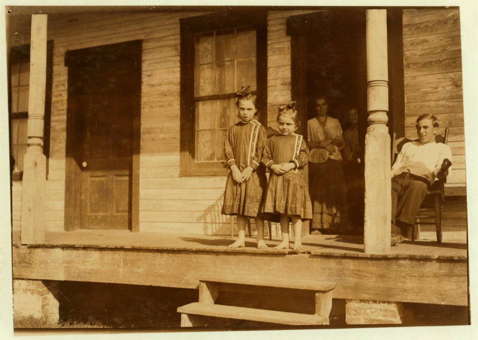 Bessie, four years old, and Marietta, seven years old, both shuck oysters in Barataria Canning Company. Mother is Mrs. Ida Thompson, Baltimore. LOC cph.3a01062