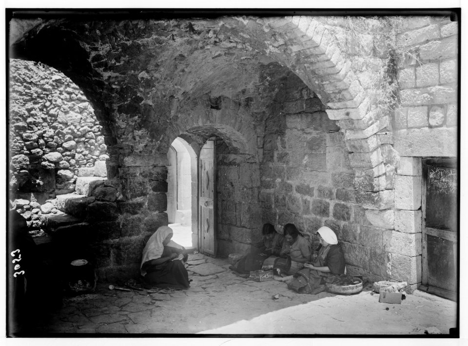 Bethlehem and surroundings. Bethlehem. Courtyard of an old home. Girls embroidering and sewing LOC matpc.02603