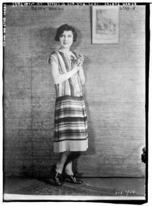 Betty Bronson modeling Roman Stripe - Orange, Green, Red & Copper Knit Pleated Skirt with Brass Buttons LCCN2014718416