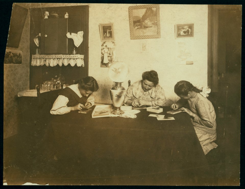 Brush-making late at night. Photo taken at 9-00 P.M., and they work later. Girls are 12 and 14 years old and go to school working in the morning before school and at night after studying is LOC nclc.04152