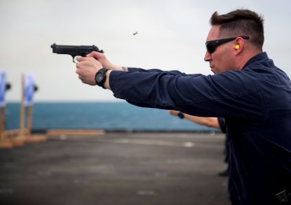 Bryan Curry firing a pistol