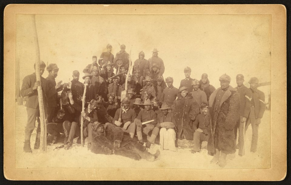 Buffalo soldiers of the 25th Infantry, some wearing buffalo robes, Ft. Keogh, Montana) - Chr. Barthelmess, photographer, Fort Keogh, Montana LCCN98501226