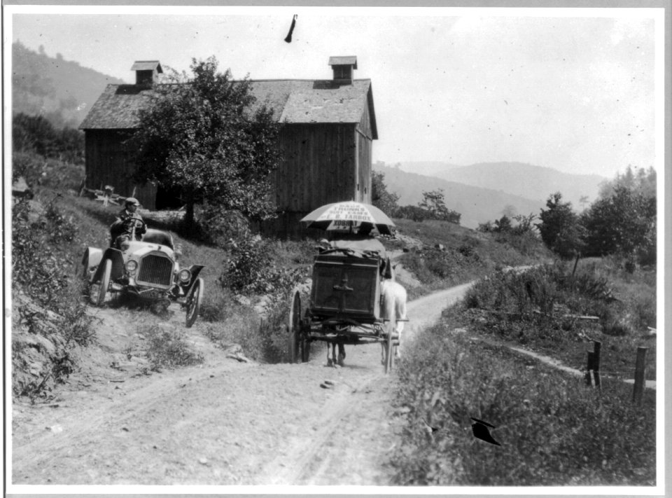 Buick roadster waits for horse-drawn wagon to pass on narrow country road above Liberty, N.Y. LCCN2005688535
