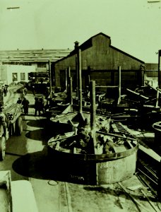 Building machine gun turrets for commercial cargo shipping, WWII (23824105856)