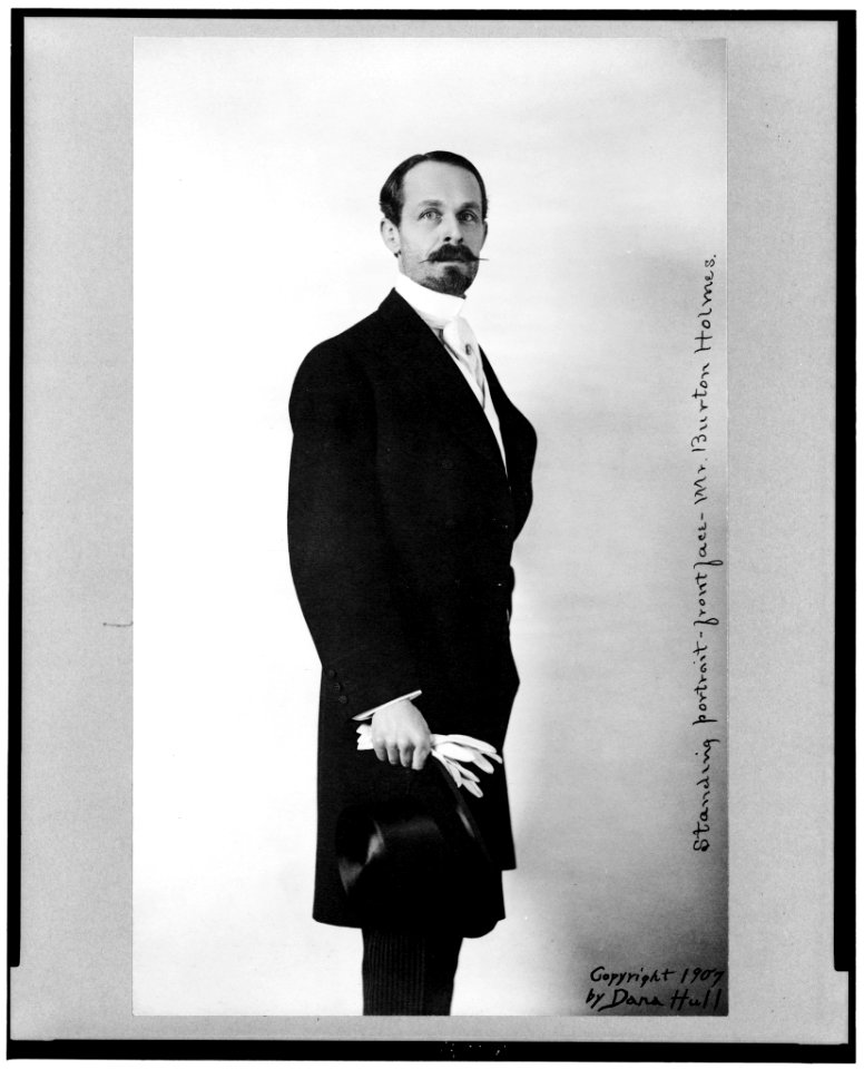 Burton Holmes, full-length portrait, standing, facing left, holding top hat LCCN91712989