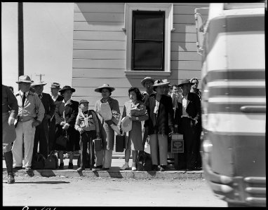 Byron, California. Families of Japanese ancestry, evacuated from Contra Costa County, await bus whi . . . - NARA - 537456 photo