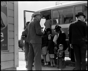 Byron, California. The bus which will take this farm family of Japanese ancestry to the Assembly ce . . . - NARA - 537459 photo