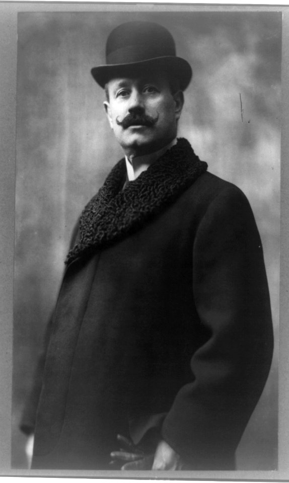 Cleofonte Campanini, half-length portrait, standing, facing front, wearing overcoat and hat LCCN93511632