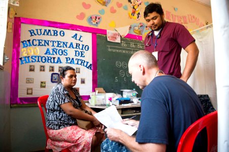 Cmdr. Jerry Chandler examines a host nation patient at the Continuing Promise 2017 (CP-17) medical site 170224-N-YL073-478