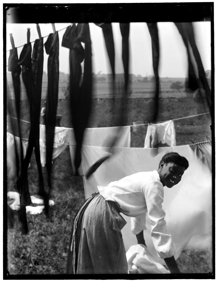 Black and white, an informal portrait of a young Negro woman surrounded by laundry in Newport, R.I. LCCN2006684226