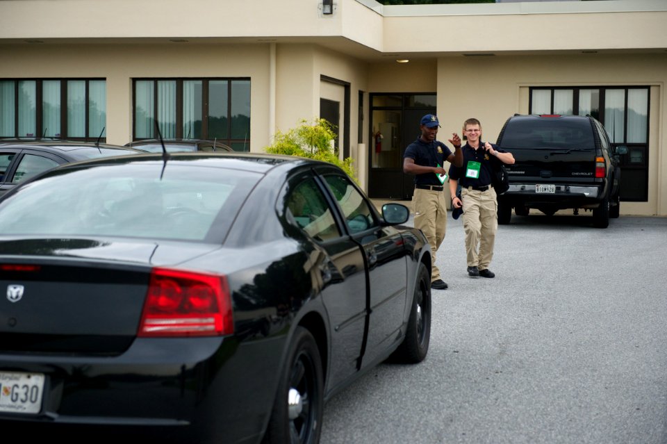 Black car and law enforcement explorers behind