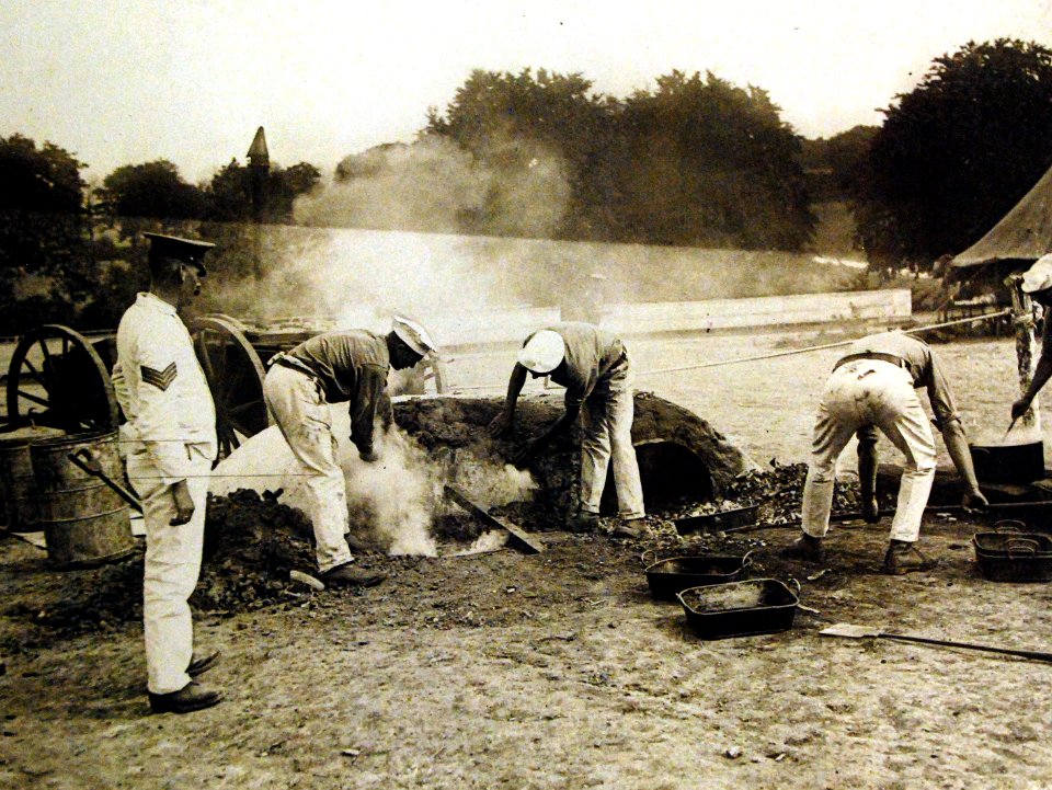 Camp kitchen, placing meat in and sealing up the ovens, British training camp, 1917 (29253261594)