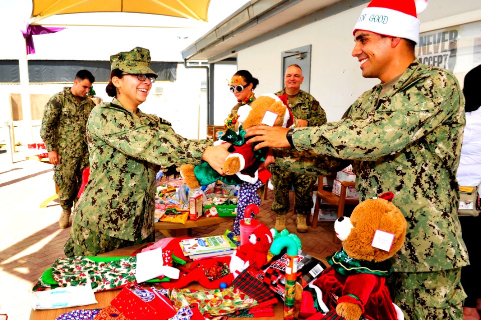 Camp Lemonnier religious programs specialists hand out Christmas gifts 141208-N-RY232-002