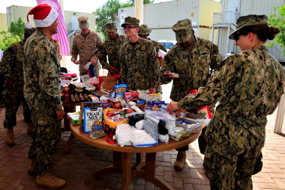 Camp Lemonnier religious programs specialists hand out Christmas gifts 141208-N-RY232-035