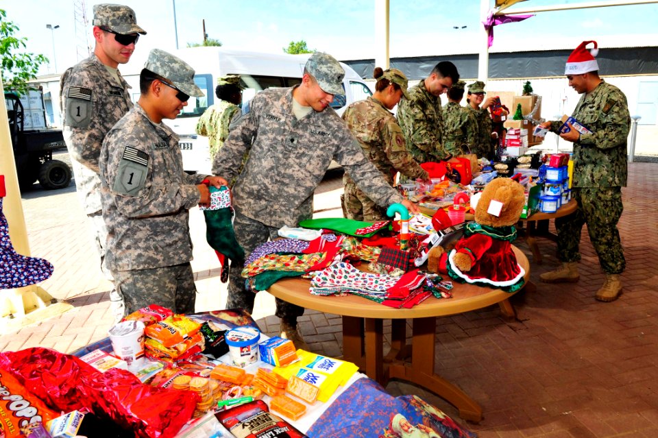 Camp Lemonnier religious programs specialists hand out Christmas gifts 141208-N-RY232-006