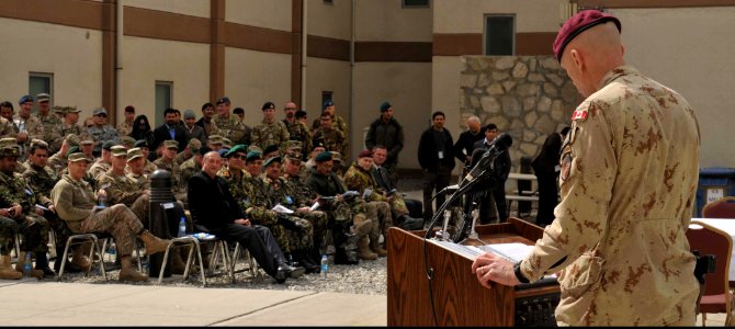 Canadian Army Brig. Gen. Wayne Eyre, at lectern, the incoming commander of NATO Training Mission-Afghanistan (NTM-A), addresses joint coalition forces during a transfer of authority ceremony March 10, 2014 140310-N-ZZ999-005