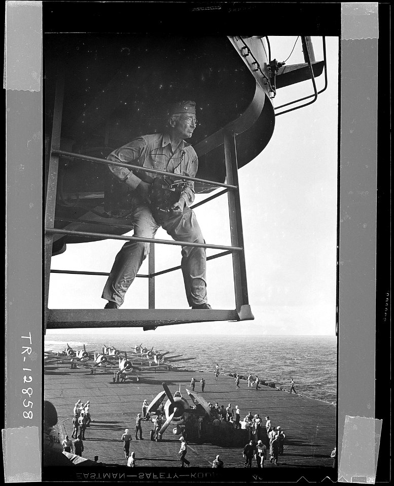 Capt. Edward J. Steichen, USNR, (retired), photographic expert, on island platform, studies his surroundings for one... - NARA - 520681