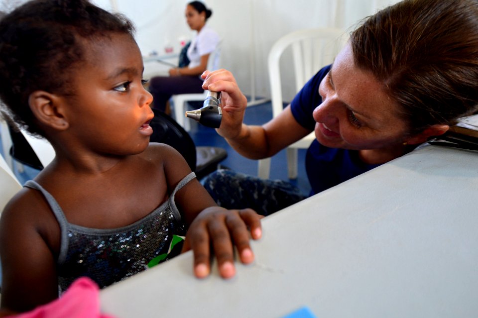Capt. Mary White examines a patient during Continuing Promise 2015. (20660757729)