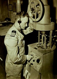 Captain G. Eklund, Merchant Marine, checks a ship's radio direction finder, 1942 (23854290345)
