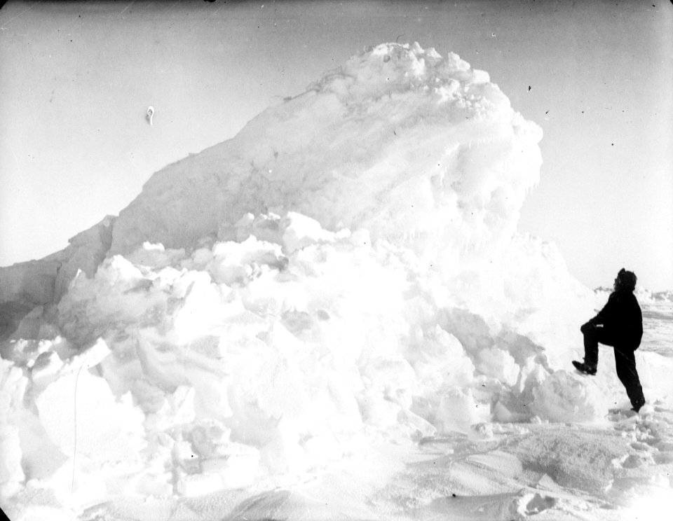 Captain Worsley standing by a large pressure ridge RMG P00008