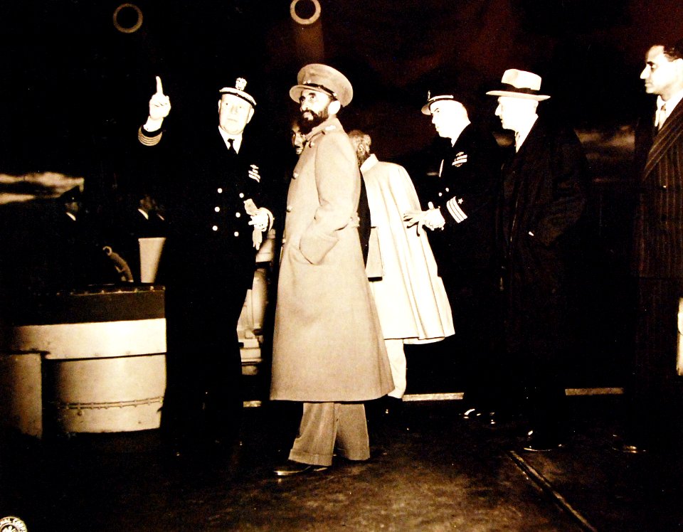 Captain Senn escorts Emperor Haile aboard USS Quincy (CA-71) on 13 February 1945 (80-G-426882)