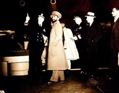 Captain Senn escorts Emperor Haile aboard USS Quincy (CA-71) on 13 February 1945 (80-G-426882)