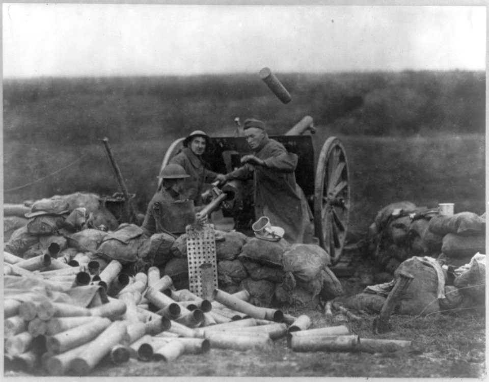 Capturing St. Mihiel Salient- 3 soldiers operating a cannon- pile of empty cannon shell casings in foreground. LCCN2016650684