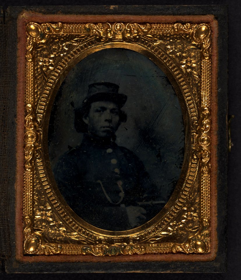 Black soldier seated with pistol in hand, watch chain in pocket LCCN2002719396